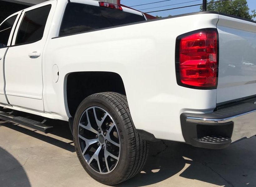 White pickup truck, rear quarter panel and bumper